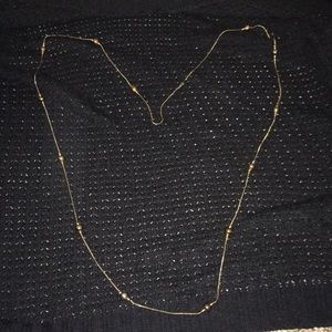 Long gold necklace with beads